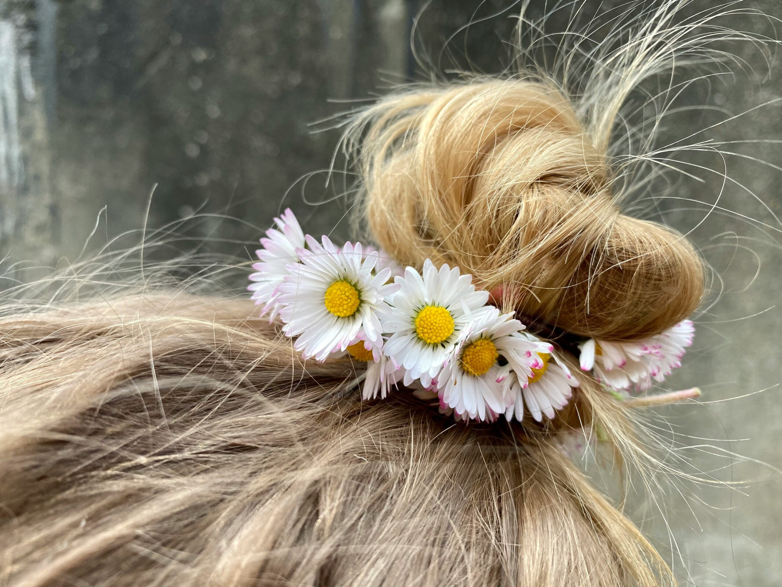 A beautifully styled hair crown with floral accents on a model