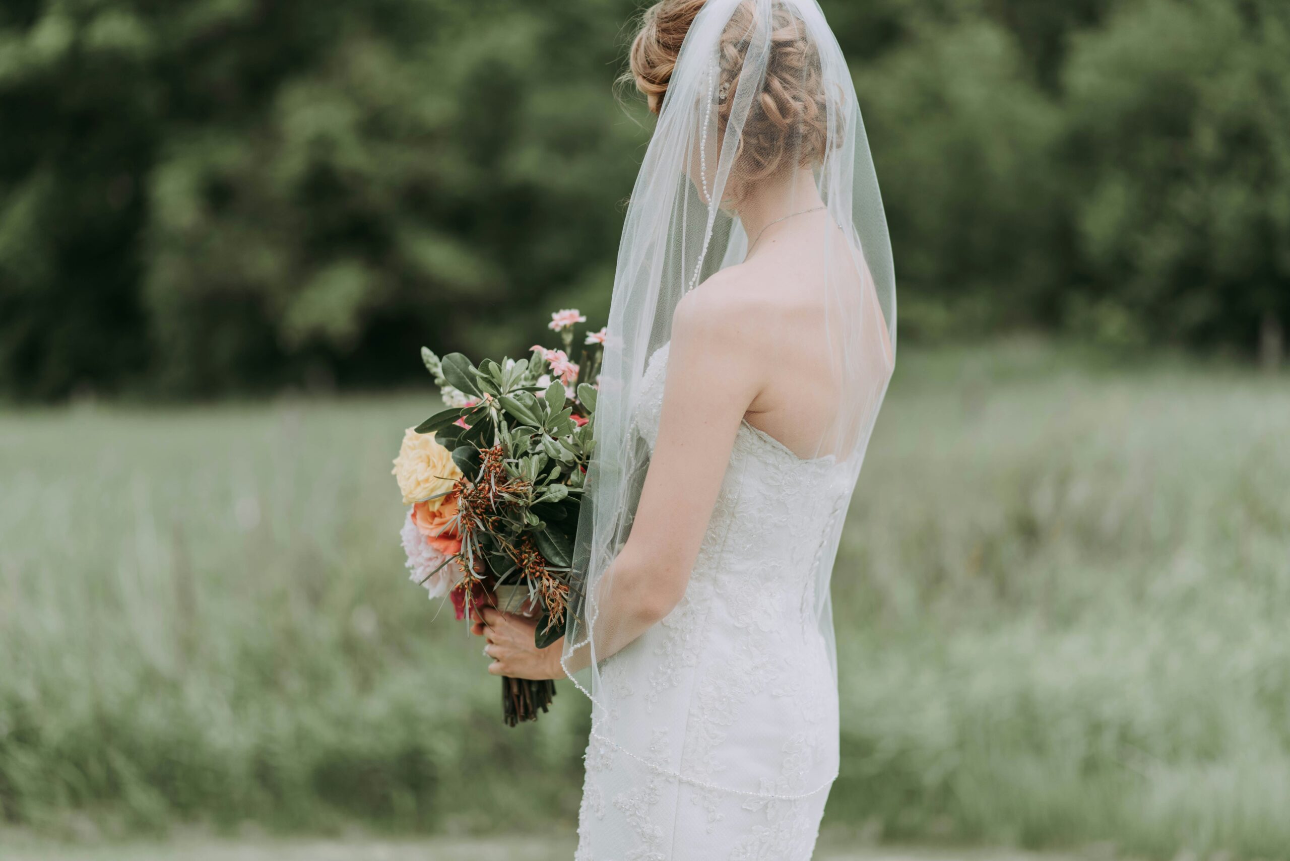 Close-up shot of a bride wearing a flower-adorned hair crown