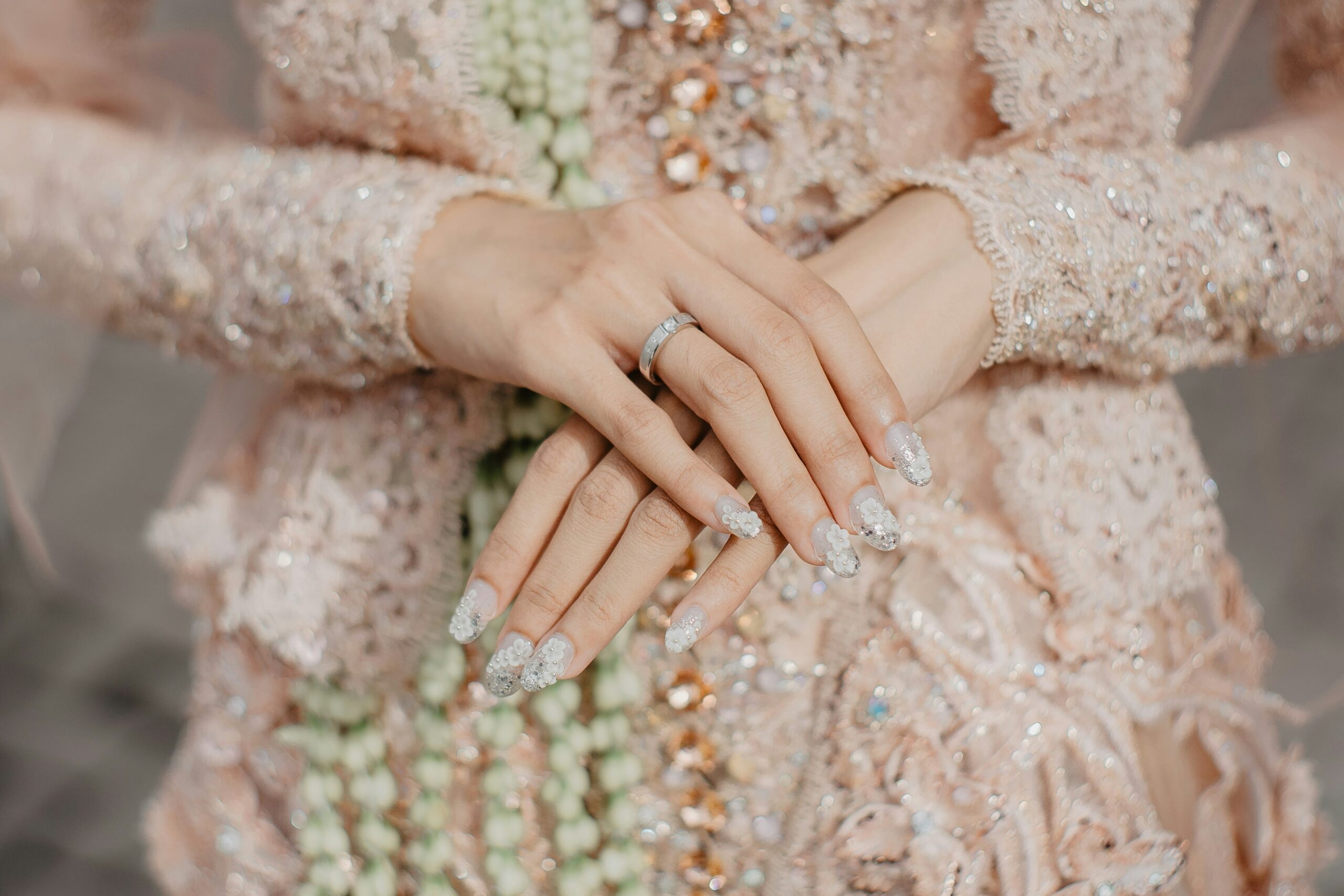 Close-up shot of hands adjusting a braided crown adorned with pearls.