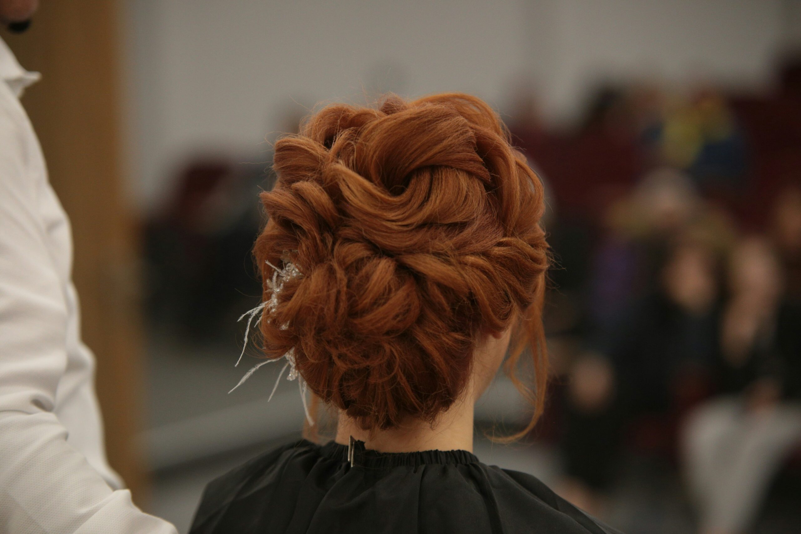 Before and after images showcasing a model's hairstyle transformation using luxe finishing crowns