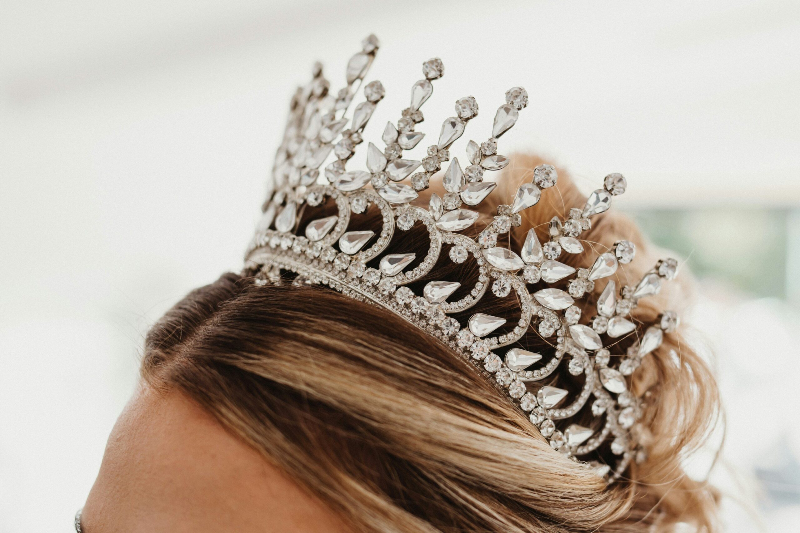 Before-and-after photo comparison of a bride wearing and not wearing a hair crown.