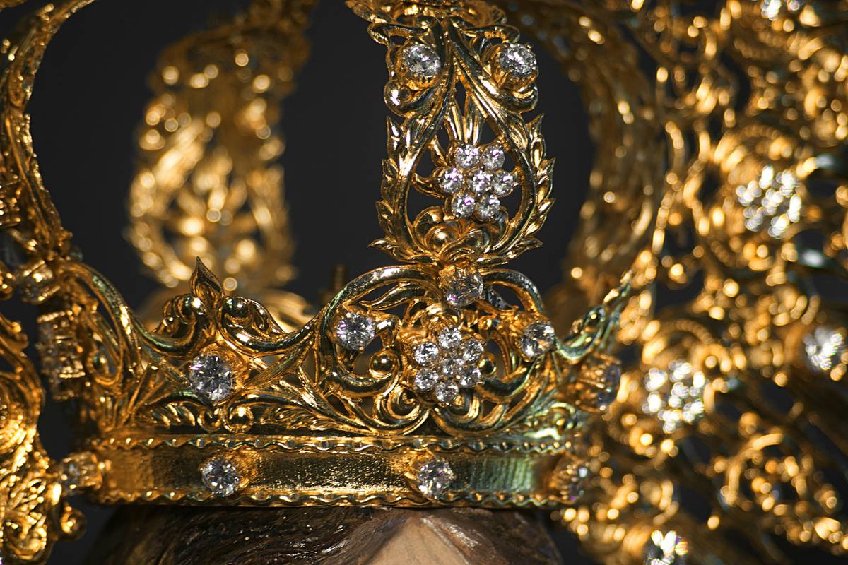 Close-up of an ornate gold vintage bridal crown adorned with pearls