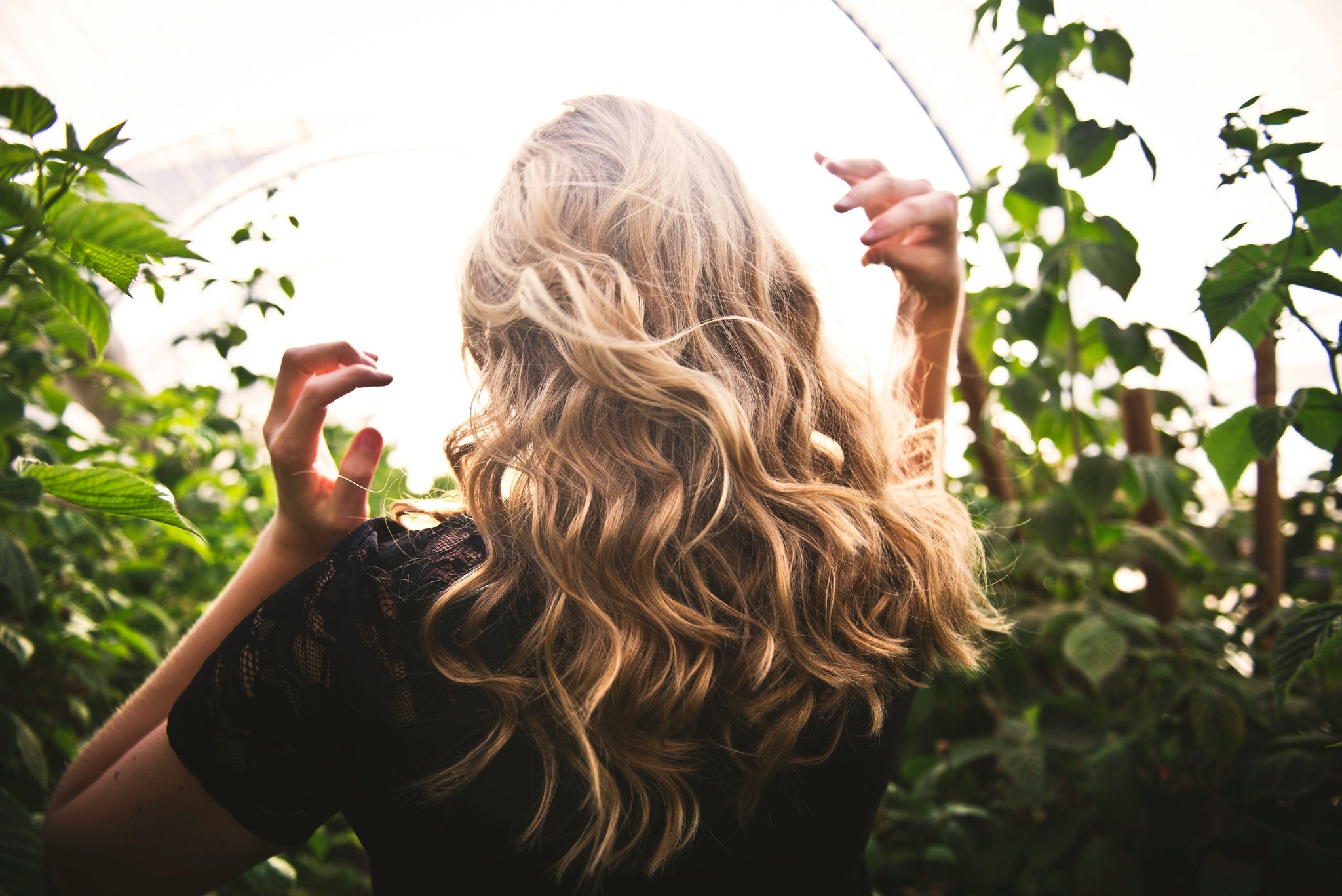 Close-up of hands securing hair crown with bobby pins