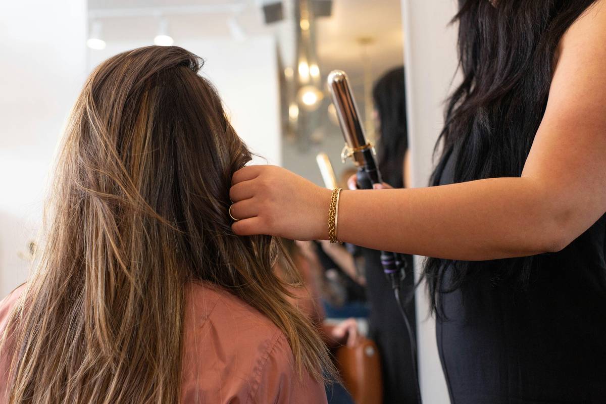 An image showing models backstage preparing their hair and makeup for a pageant