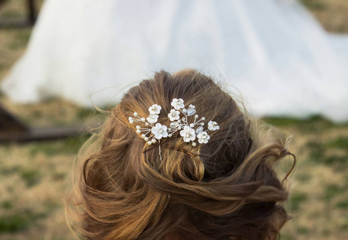A real bride smiling with her floral modern bridal headpiece perfectly matching her bouquet.
