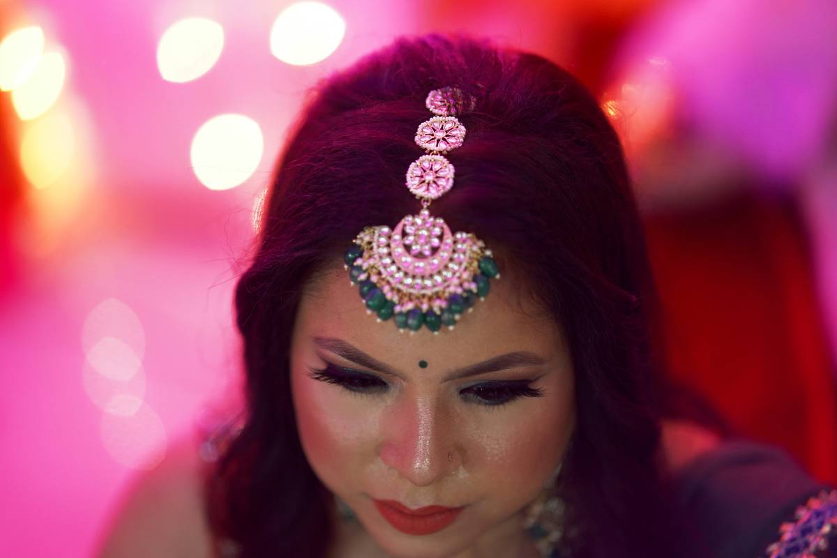 Bride wearing an authentic pearl-encrusted crown handed down through generations