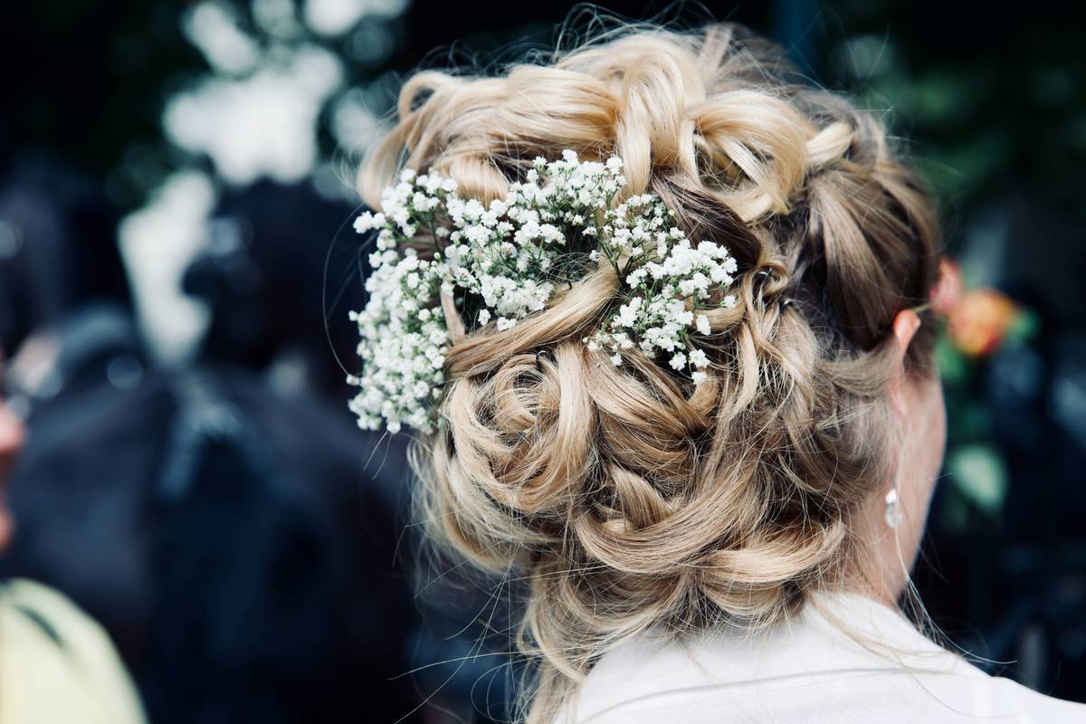 Close-up shot of a bride adjusting her delicate tiara before walking down the aisle.