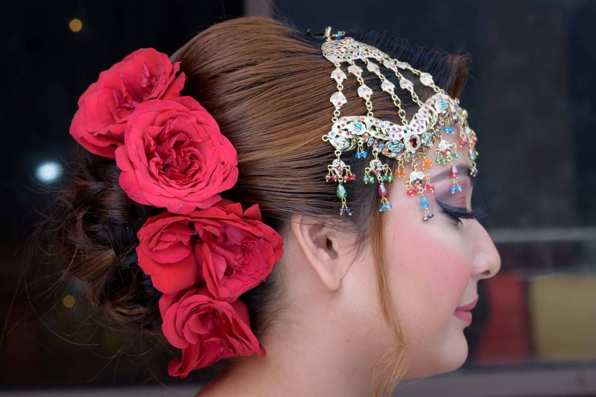 Celebrity photo featuring intricate silver crown paired with flowing gown.
