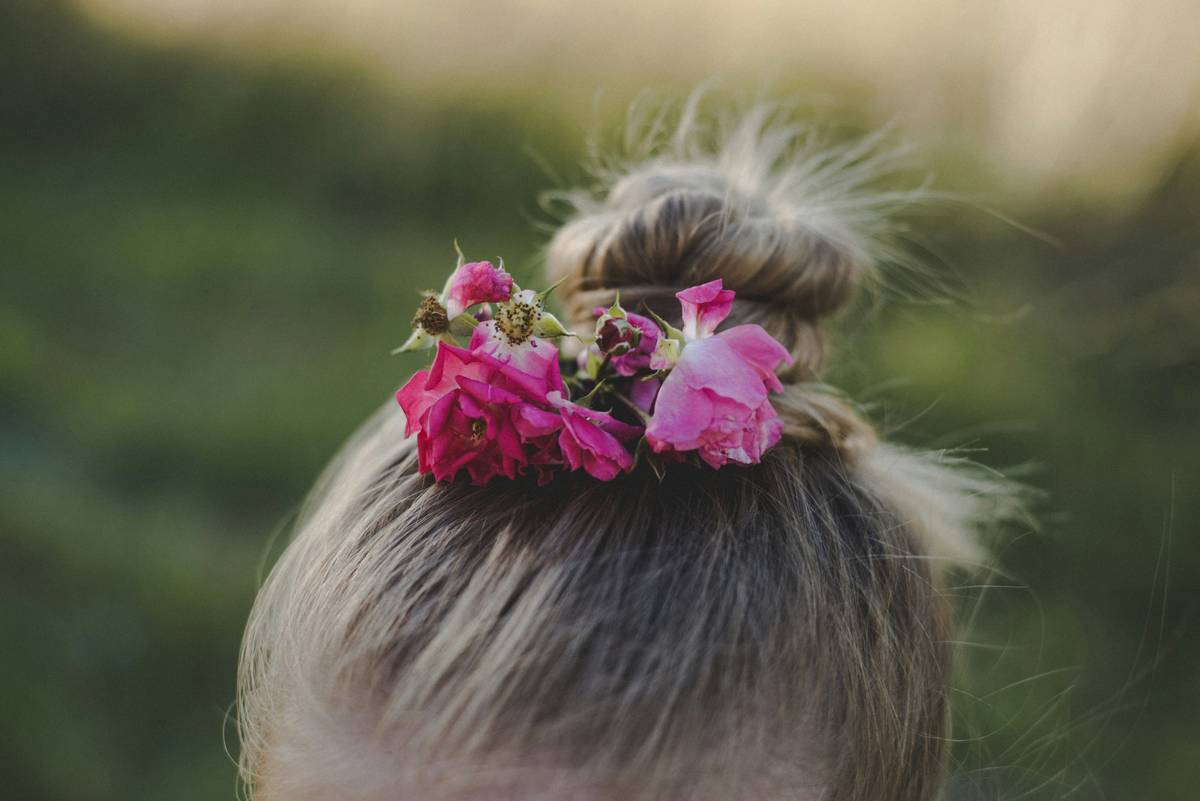 Close-up of different materials used in making hair crowns, including faux flowers, pearls, and metals.