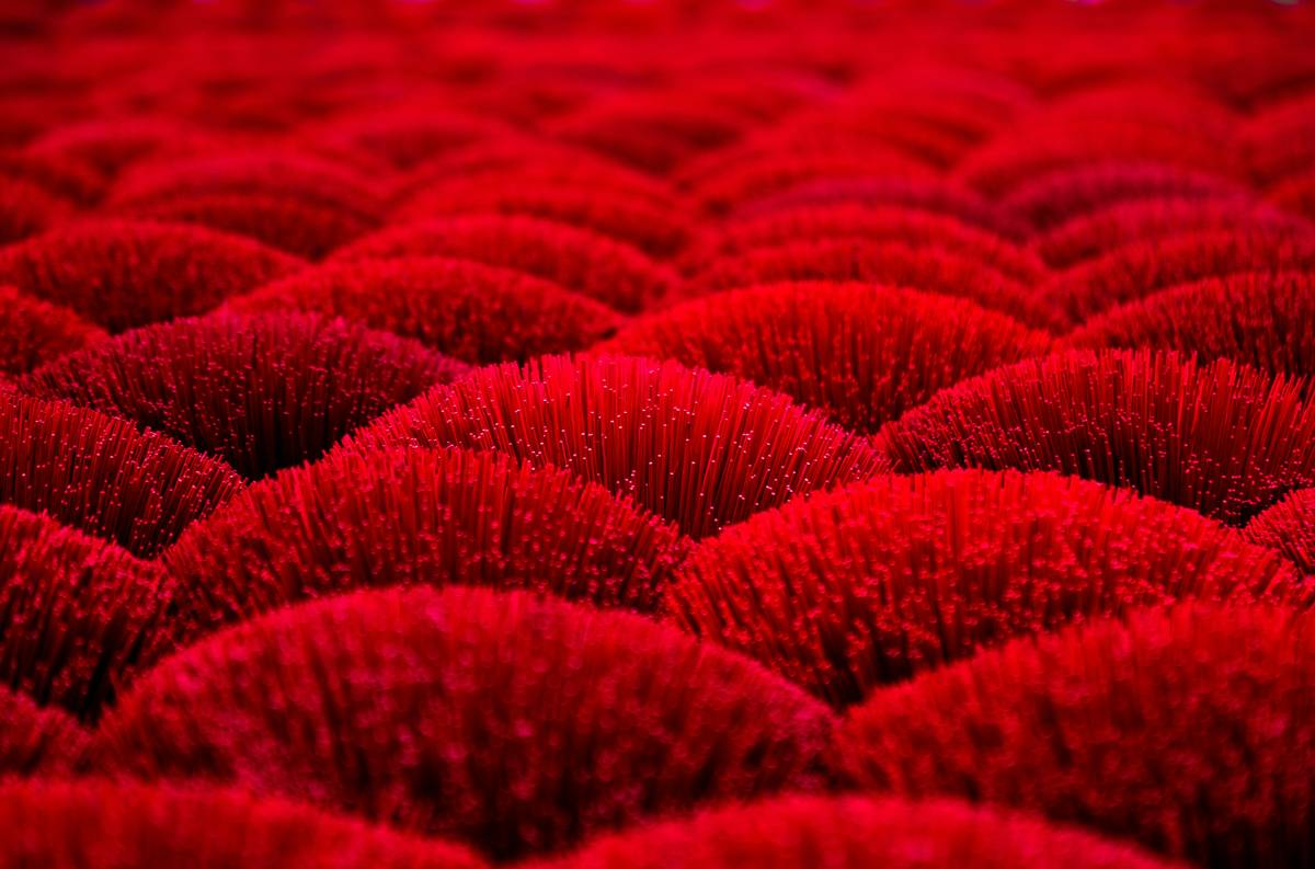 Lady Gaga smiling confidently on the red carpet, wearing a bold diamond-encrusted hair crown.