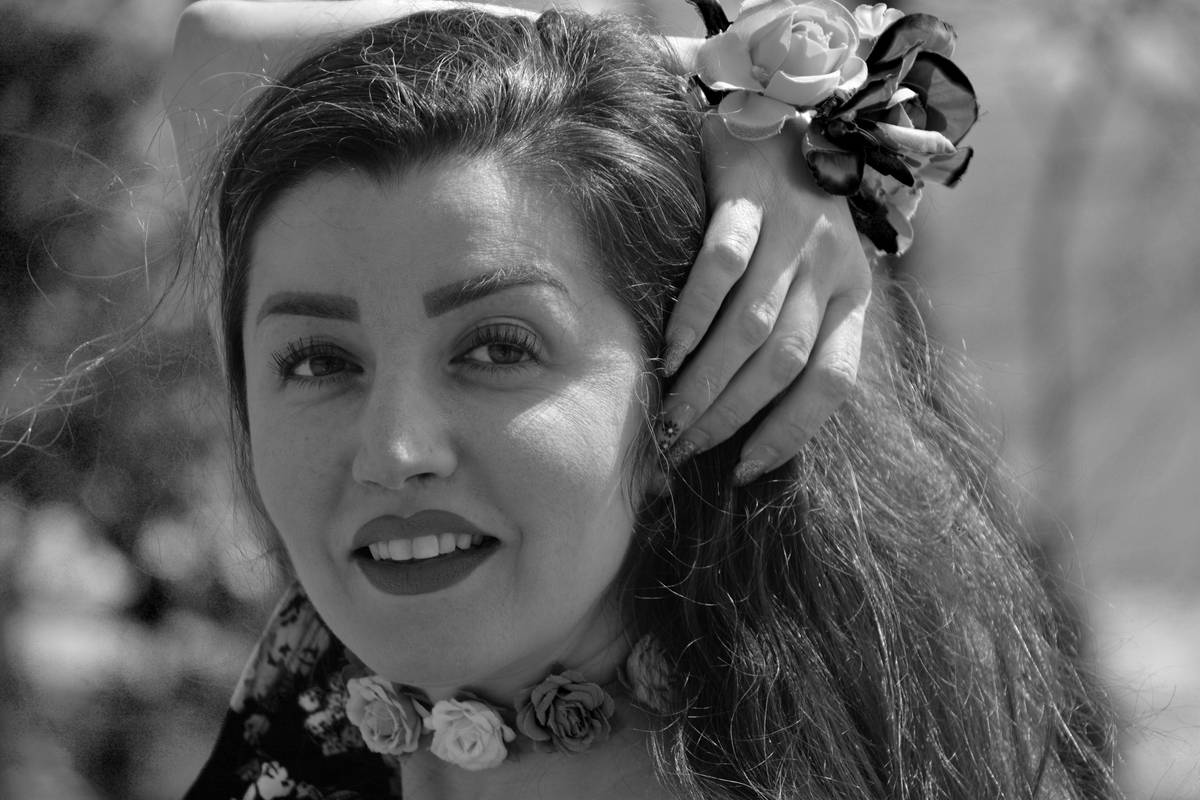 A model wearing a floral festival tiara against neon lights