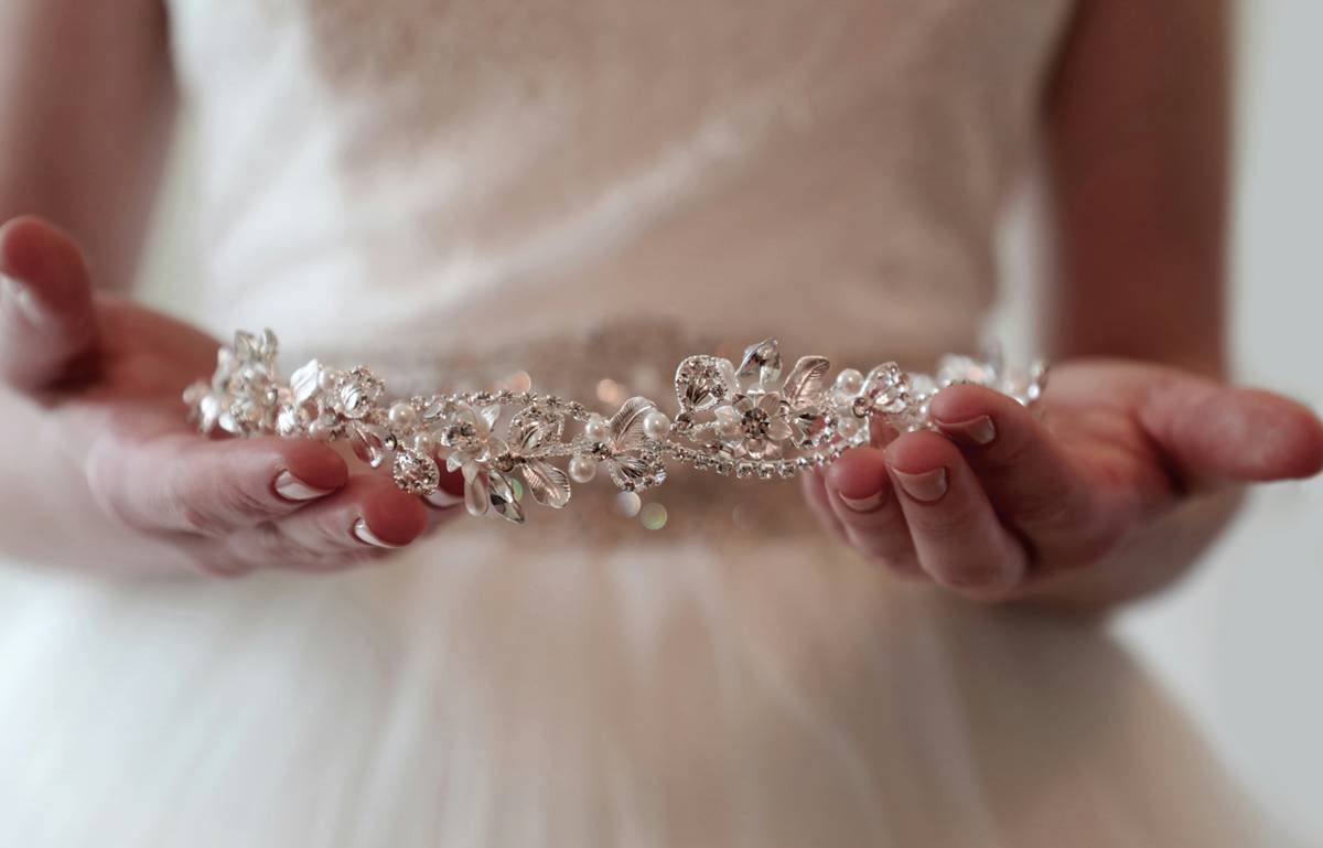 Model wearing an elegant bridal hairband adorned with pearls and crystals